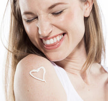 Load image into Gallery viewer, Glow Day Spa Barrie NEW Honey Chai Steeped Milk Lotion for nouroishing therapy for dry skin on hands. Model with heart emoji